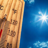 Heat stroke symptoms represented by thermometer on hot summer day