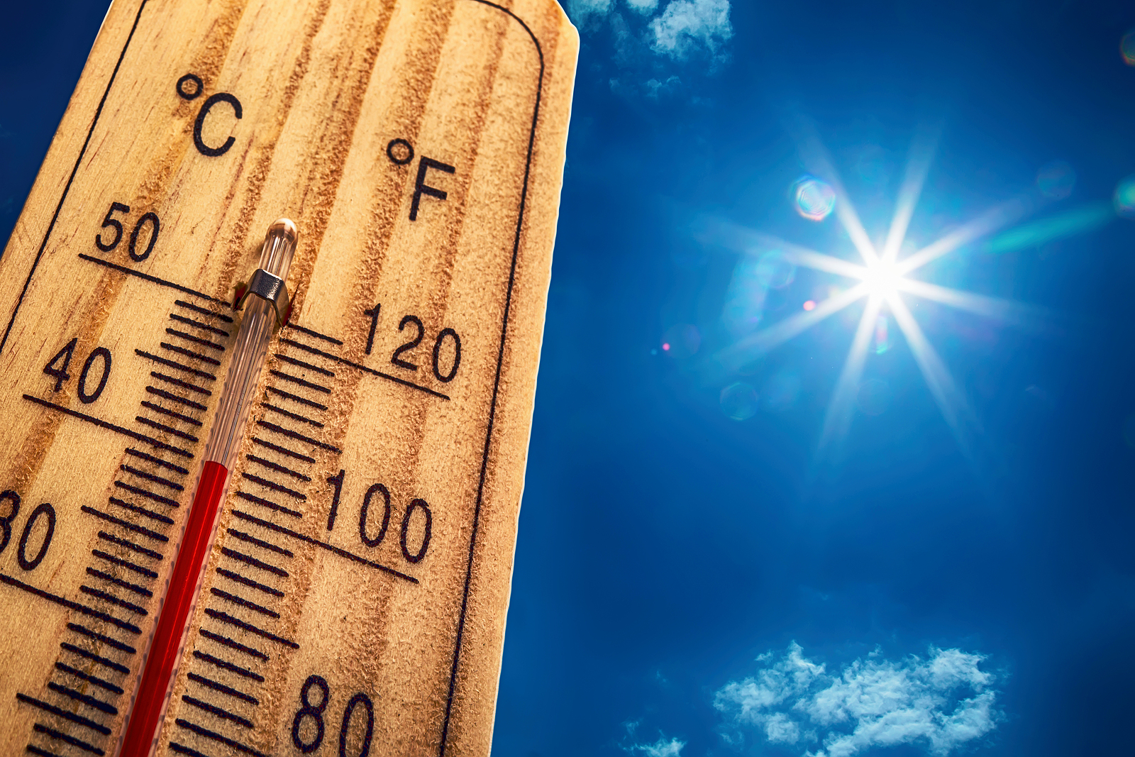 Heat stroke symptoms represented by thermometer on hot summer day