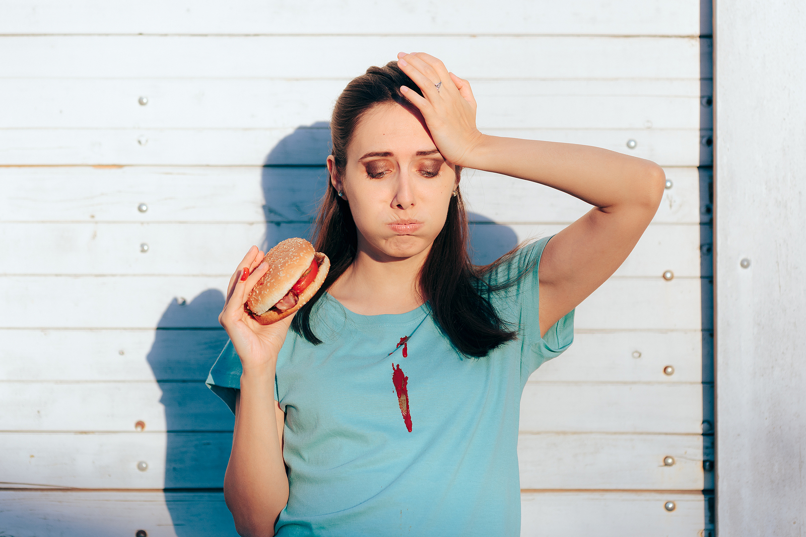 Stain removal chart is needed by unhappy woman with stain on shirt