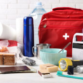 emergency supply lists tp print represented by photo of first aid kit and other list contents