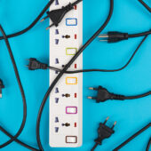 A power strips and electrical cords on a tuquoise background